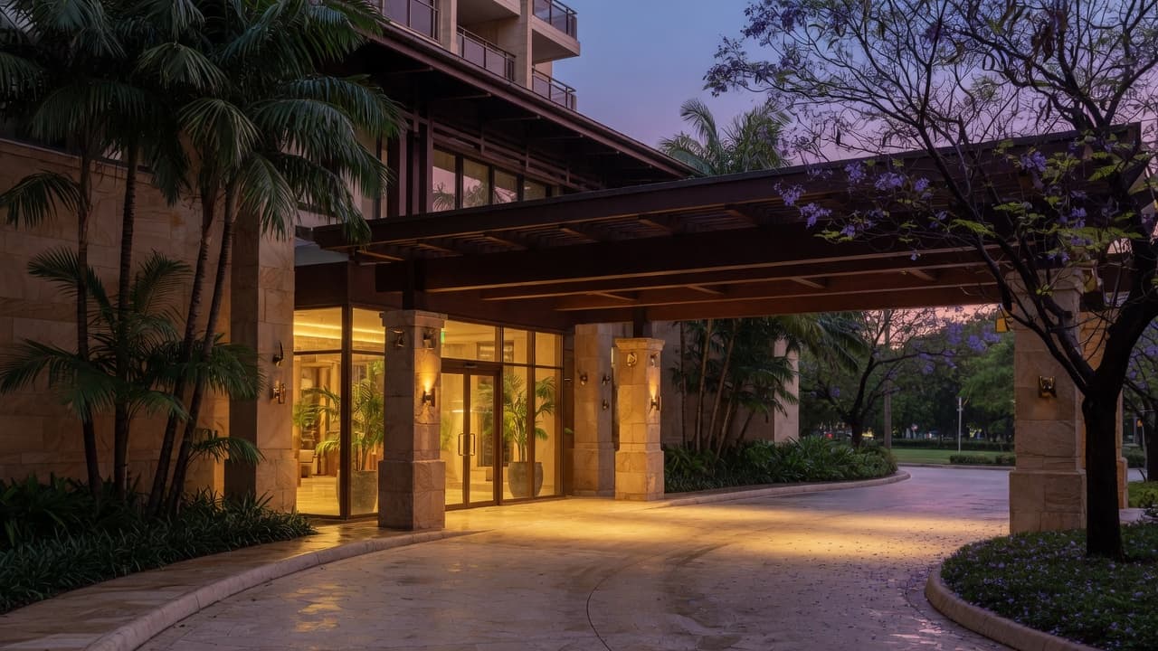 Apartment entrance under a porte-cochere at dusk. Lead image for “How should committees respond to building alarms and faults?”. Atmospheric photography, not a named building.